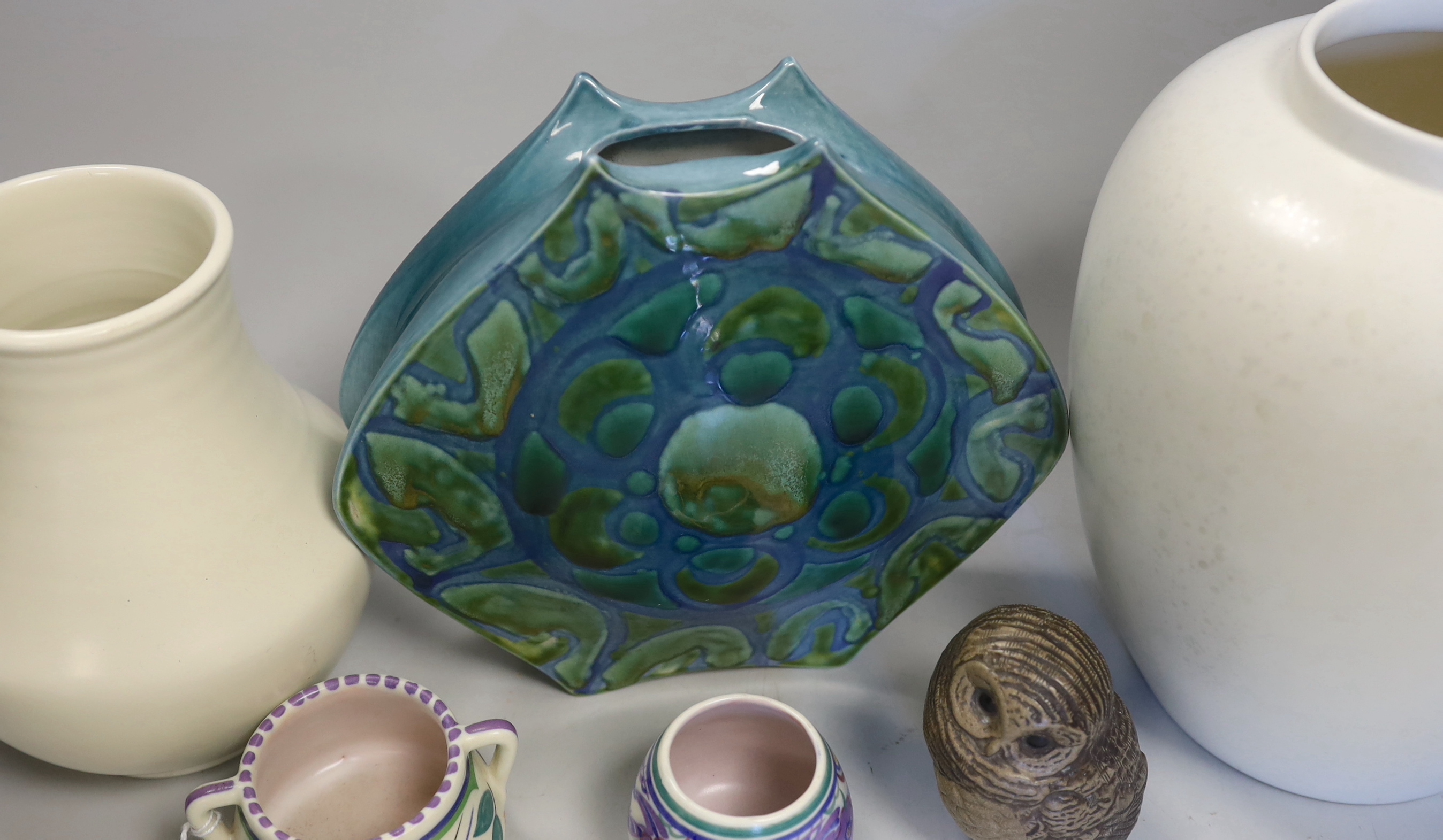 Six Poole pottery items including three vases, two miniature pots and an owl, tallest vase 22cm